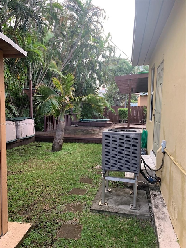 view of yard featuring a deck and cooling unit