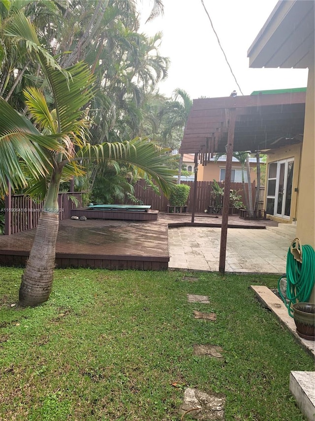 view of yard with a wooden deck, a pergola, and a patio area