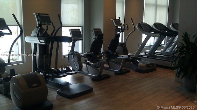 exercise room with dark wood-type flooring