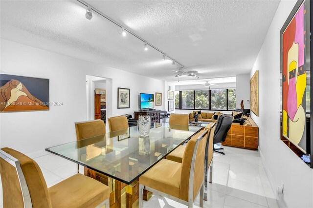 6320 Boca Del Mar Dr Unit 207, Boca Raton, FL 33433 - dining area with track lighting, light tile patterned floors, a textured ceiling, and baseboards