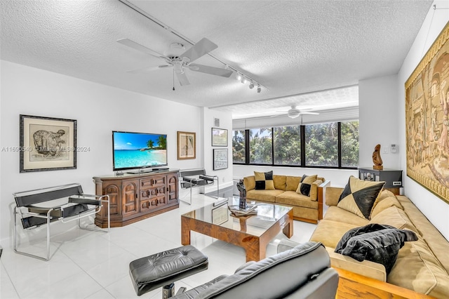 living room with ceiling fan, a textured ceiling, and rail lighting