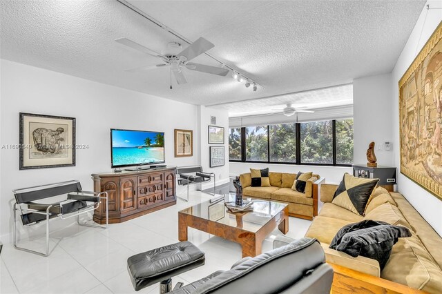 6320 Boca Del Mar Dr Unit 207, Boca Raton, FL 33433 - living area featuring ceiling fan, a textured ceiling, rail lighting, and tile patterned flooring