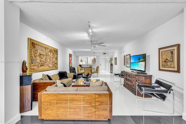 tiled living room with track lighting, a textured ceiling, and ceiling fan