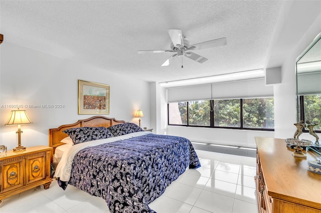 tiled bedroom featuring a textured ceiling and ceiling fan