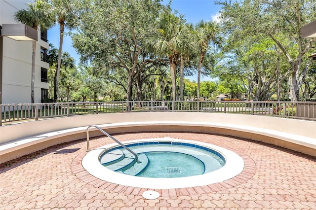 view of swimming pool with a community hot tub