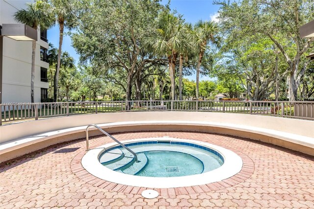 6320 Boca Del Mar Dr Unit 207, Boca Raton, FL 33433 - view of swimming pool featuring a community hot tub and view of wooded area