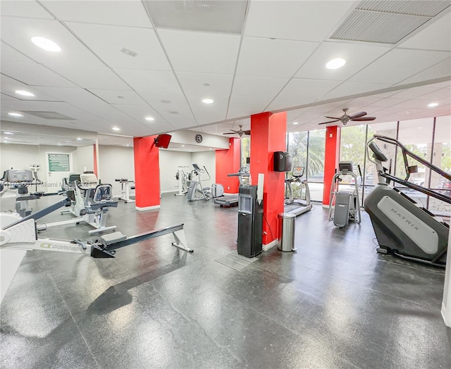 exercise room featuring a paneled ceiling and ceiling fan