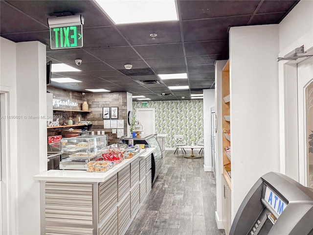 kitchen featuring a drop ceiling and hardwood / wood-style flooring