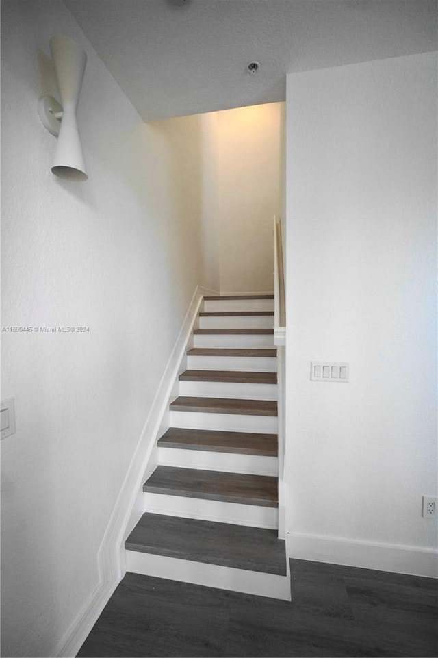 stairs with wood-type flooring