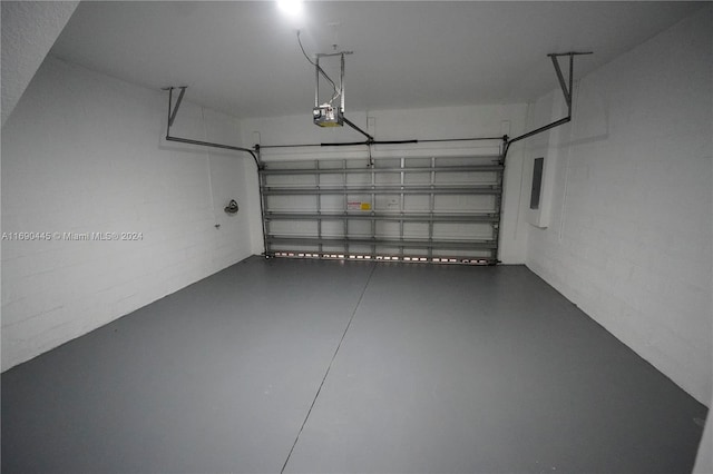 garage featuring a garage door opener and electric panel