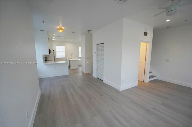 123 Harbors Way, Boynton Beach, FL 33435 - unfurnished living room with ceiling fan, light wood-style flooring, baseboards, and recessed lighting