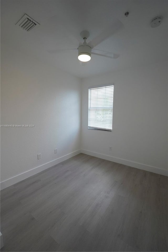 spare room featuring hardwood / wood-style floors and ceiling fan