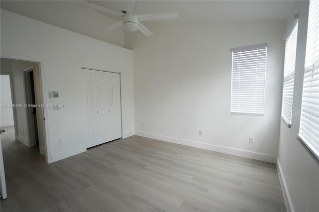 123 Harbors Way, Boynton Beach, FL 33435 - unfurnished bedroom featuring wood finished floors, baseboards, multiple windows, and lofted ceiling
