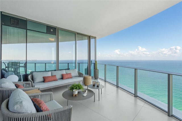 balcony with an outdoor hangout area and a water view