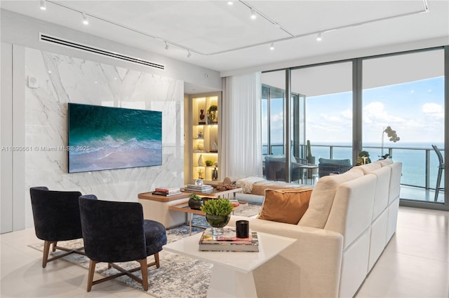 tiled living room with a water view and a wall of windows