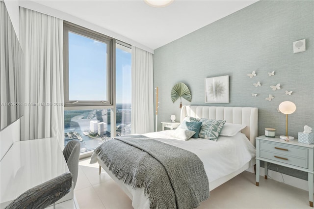 tiled bedroom with expansive windows and multiple windows