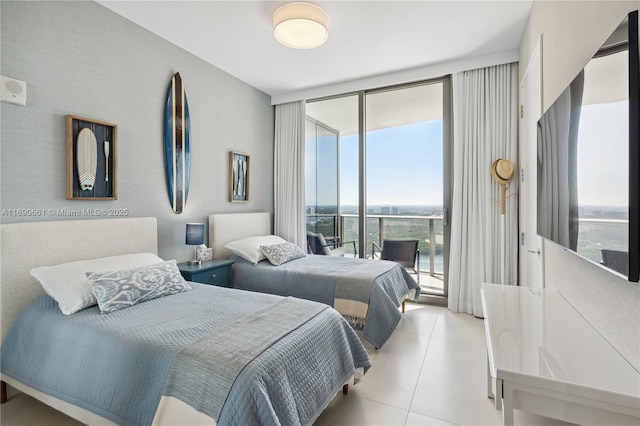 tiled bedroom with a wall of windows and access to outside