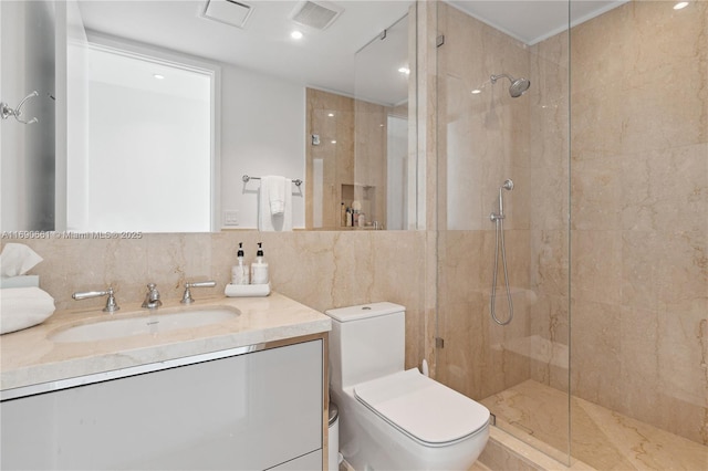 bathroom featuring toilet, tile walls, a tile shower, decorative backsplash, and vanity