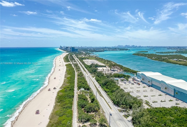 drone / aerial view featuring a water view and a view of the beach