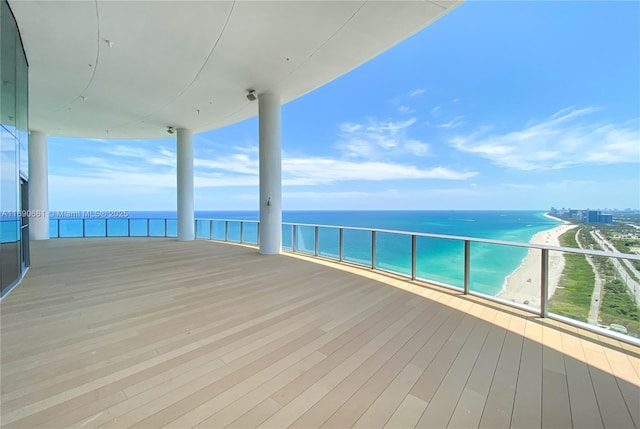 deck with a water view and a view of the beach