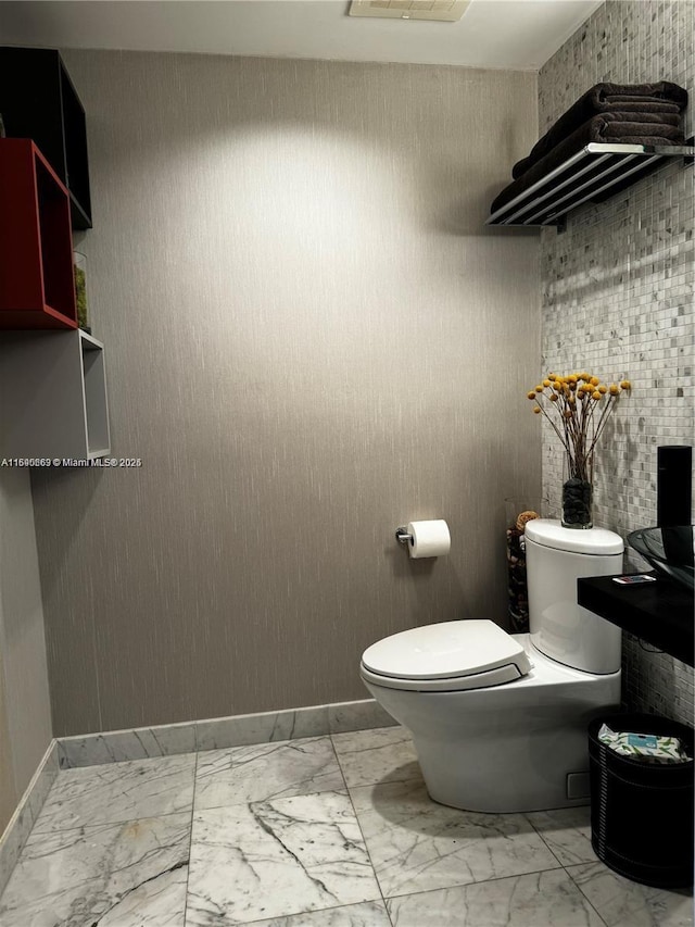 200 Biscayne Boulevard Way Unit 3110, Miami, FL 33131 - bathroom with marble look tiles, toilet, and baseboards