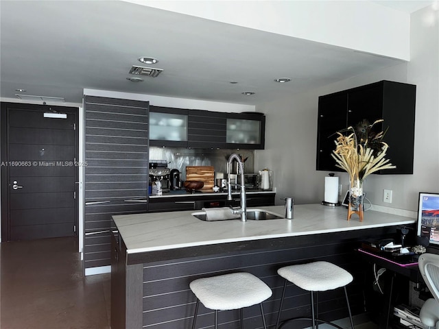 200 Biscayne Boulevard Way Unit 3110, Miami, FL 33131 - kitchen featuring glass insert cabinets, a breakfast bar, a sink, and a peninsula