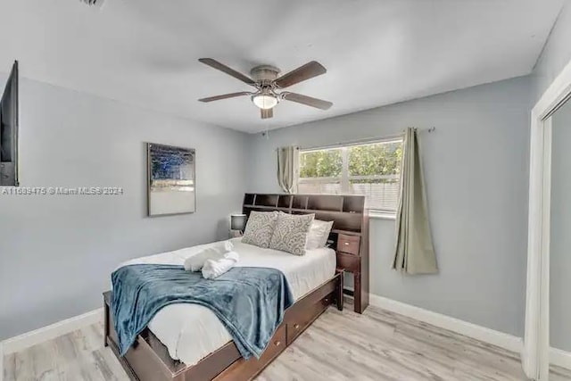 bedroom with ceiling fan and light hardwood / wood-style flooring