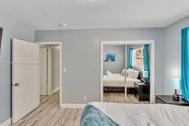 bedroom featuring light wood-type flooring and a closet