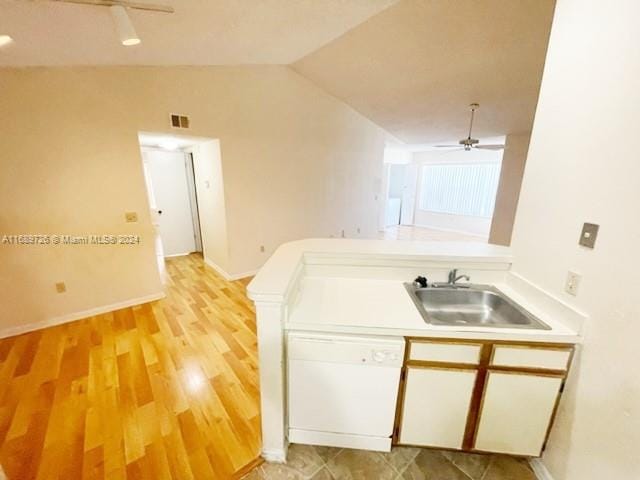 kitchen featuring ceiling fan, light wood-type flooring, sink, and vaulted ceiling