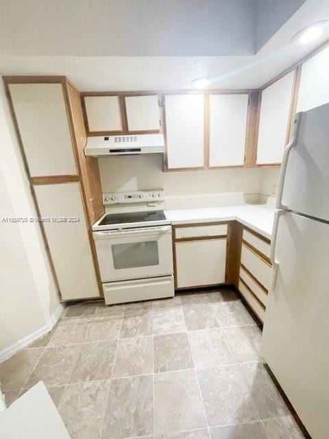 kitchen with white appliances, white cabinetry, and range hood