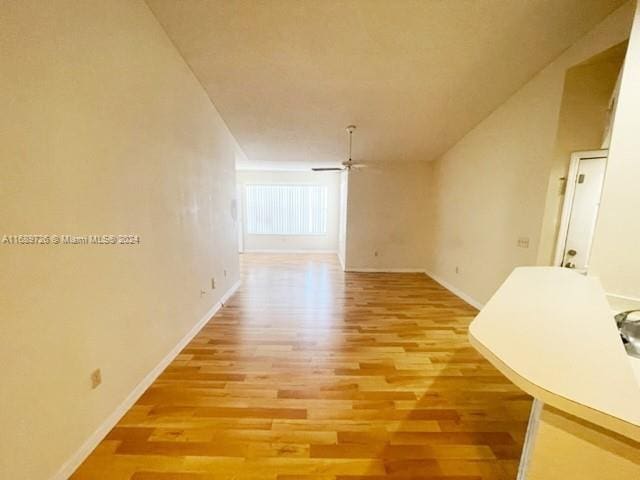 hallway with light hardwood / wood-style floors