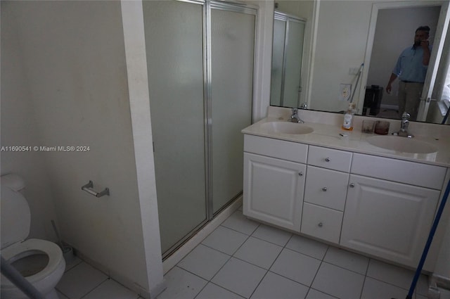 bathroom featuring walk in shower, vanity, toilet, and tile patterned floors