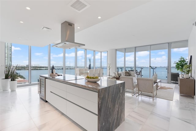 interior space with beverage cooler and a water view