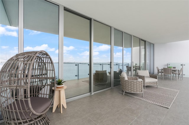 balcony with a water view and outdoor dining space