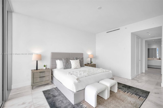 bedroom featuring baseboards and visible vents