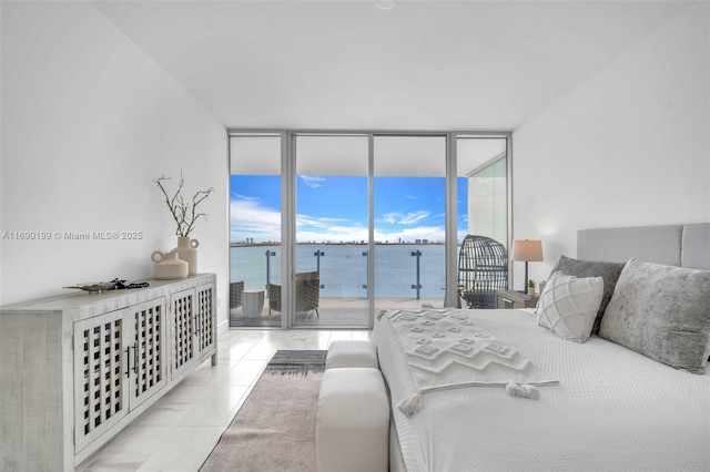 bedroom with access to exterior, light tile patterned floors, floor to ceiling windows, and a water view