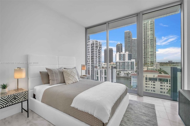 bedroom featuring floor to ceiling windows, a water view, light tile patterned floors, and access to exterior