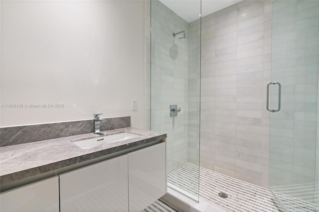full bath with vanity and a shower stall