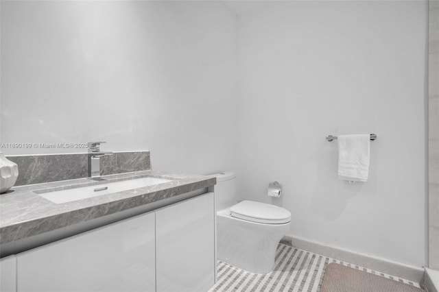 bathroom with vanity, tile patterned flooring, and toilet