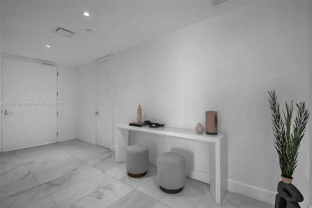 interior space featuring baseboards, visible vents, recessed lighting, and marble finish floor