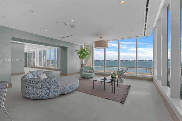 living room with baseboards and a water view