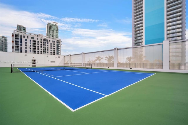 view of tennis court featuring fence