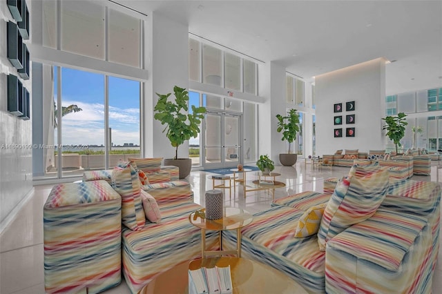 living area with a high ceiling and french doors