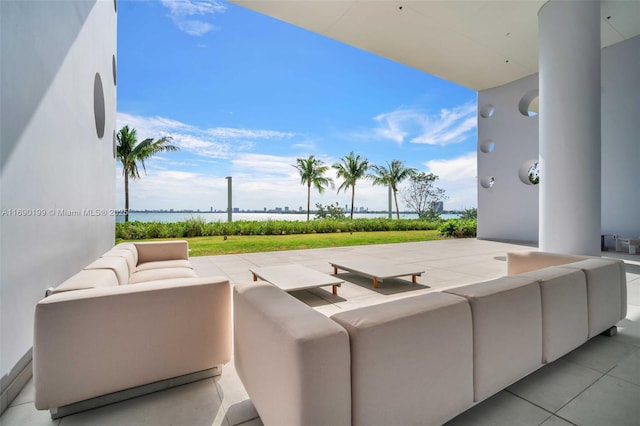 view of patio with a water view and outdoor lounge area