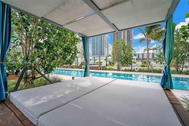 outdoor pool featuring a view of city and a patio area