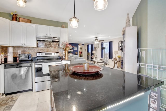 kitchen featuring white cabinetry, light tile patterned floors, decorative light fixtures, and appliances with stainless steel finishes