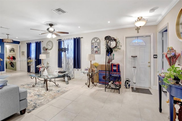 entrance foyer featuring ceiling fan, light tile patterned floors, and crown molding