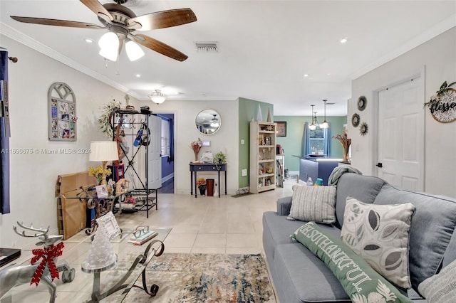 tiled living room featuring ceiling fan with notable chandelier and ornamental molding