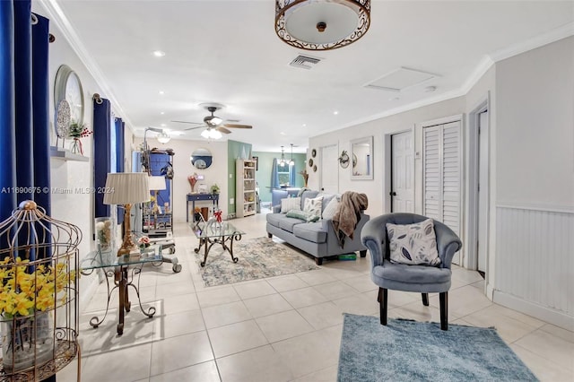 living room with light tile patterned floors, ceiling fan, and crown molding