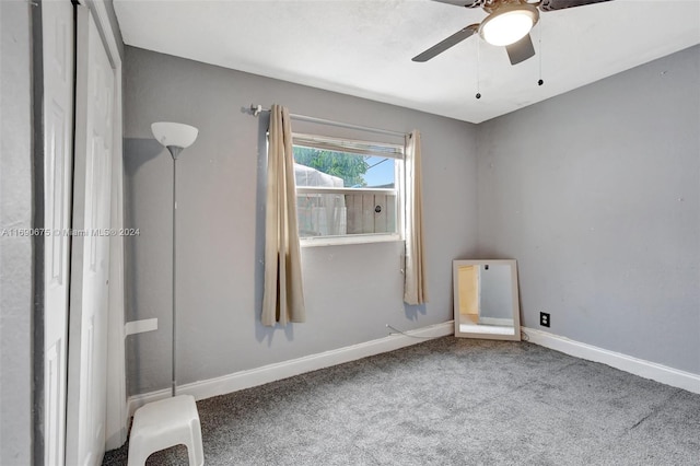 interior space with ceiling fan and carpet flooring